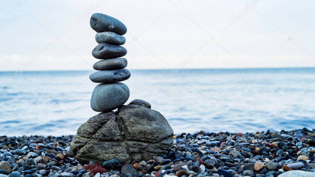 Stone tower of pebbles on sea shore