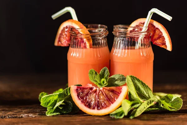Jars of fresh blood orange juice, selective focus — Stock Photo, Image