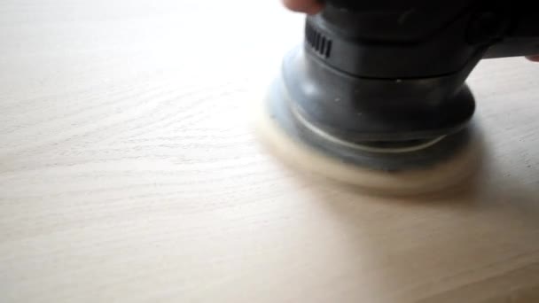 Man sanding wood with orbital sander in a workshop — Stock Video