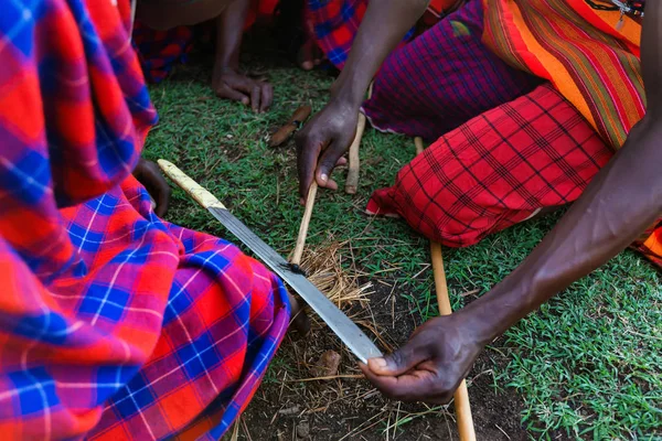 Maasai people show process of making fire