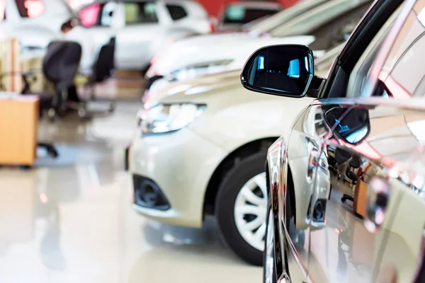 New cars at dealer showroom blurred background — Stock Photo, Image