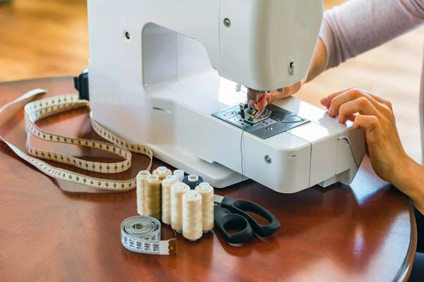 Dressmaker or seamstress works using sewing machine — Stock Photo, Image