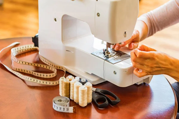 Dressmaker or seamstress works using sewing machine — Stock Photo, Image