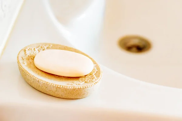Soap on a dish over ceramic sink — Stock Photo, Image