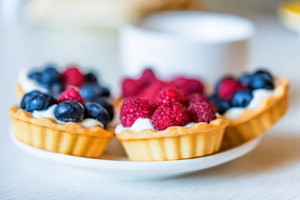 Sweet tarts with mixed berries on a plate — Stock Photo, Image