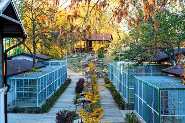 stock image Bird cages in the outdoor zoo with benches