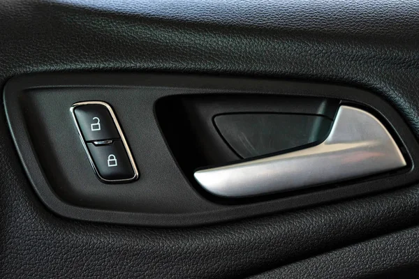 Modern plastic car door handle from inside close — Stock Photo, Image
