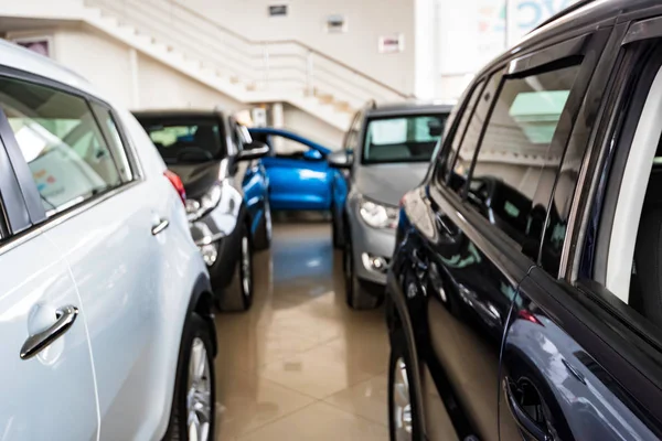 New cars at dealer showroom blurred background — Stock Photo, Image