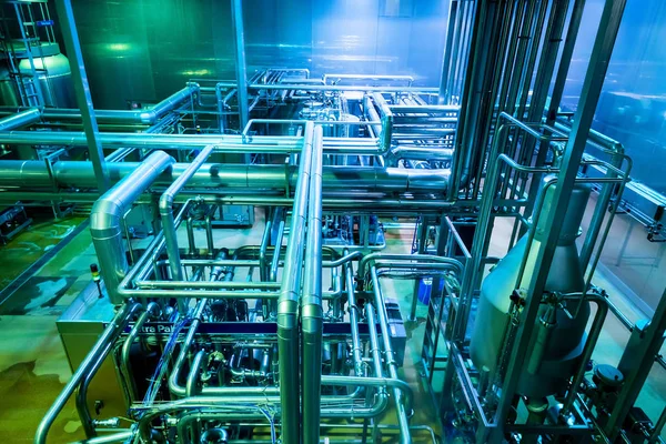 Industrial interior of soft drinks factory with tubes