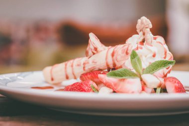 Lezzetli tatlı waffle ile yakından rulo, dondurma ve çilek