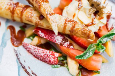 Lezzetli tatlı waffle ile yakından rulo, dondurma ve çilek