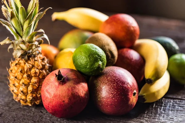 Studio shot of various exotic fruit on wood — Stock Photo, Image