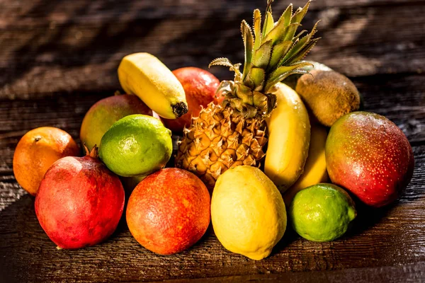 Studio shot of various exotic fruit on wood — Stock Photo, Image