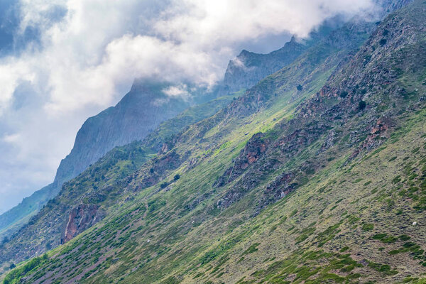 Scenic view of foggy mountains. Clouds and green mountain forest view