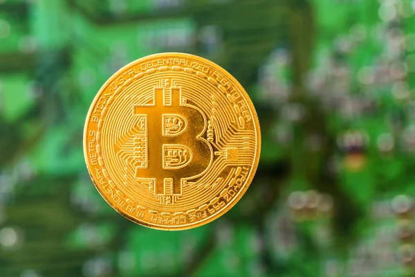 Golden brand new bitcoin on green digital background — Stock Photo, Image