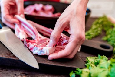 Cook kızartma tavası yakın çiğ kuzu kaburga koyar