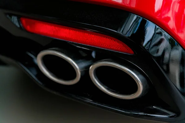 Exhaust pipe of a modern sport red car Stock Image