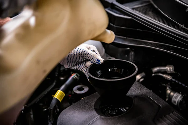 Close-up of oil change in a car during service. Stock Image