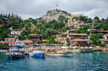 Dağda şatosu olan antik Simena köyü. Tekne iskelesi, güzel manzara. Demre yakınlarındaki Kekova adasında Lycian sualtı şehri deniz turu. Antalya vilayeti. Kalekoy, Türkiye 11 Haziran 2018