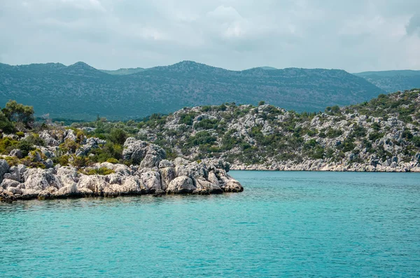 Seascape. Pohled z vody na ostrovy ve Středozemním moři. Nezkažená příroda Turecka. Kamenné útesy a hory pokryté zelenými keři a stromy. Letní krajina z rekreační lodi. — Stock fotografie