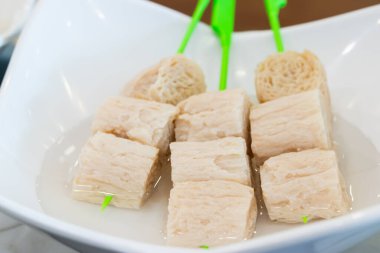 Suya batırılmış tofu şişleri pişirme, vejetaryen yemeği ve sağlıklı yemek konsepti için hazırlanmış soya peyniri küplerini gösteriyor..