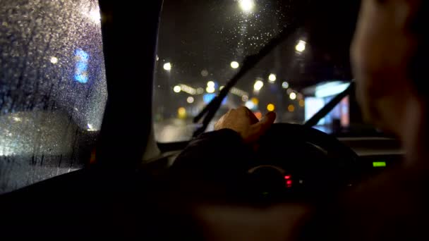 Driver eating behind steering wheel in the car parked by the city road — Stock Video