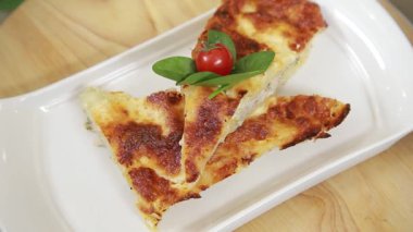 Freshly baked crusty chicken and pumpkin lasagna slices served on a plate