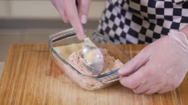 Chef is cooking lasagna with tuna patte