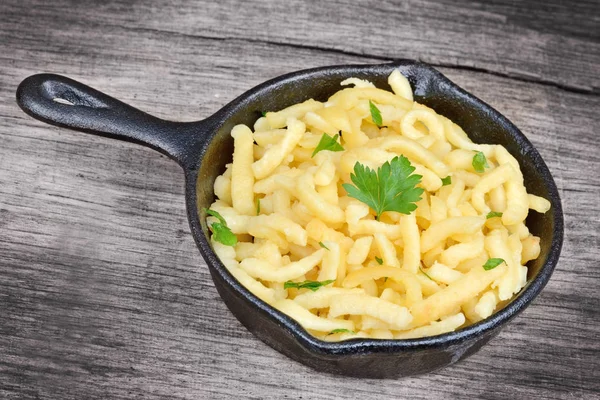 Eski ahşap masa üzerinde spatzle ile pan