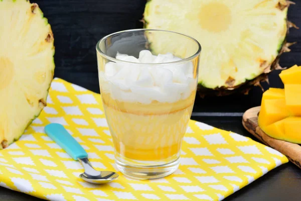 Mousse of pineapple fruit and mango in a glass jar on table — Stock Photo, Image