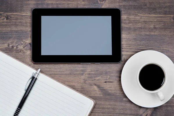 Empty digital tablet pc with notebook and coffee on table — Stock Photo, Image