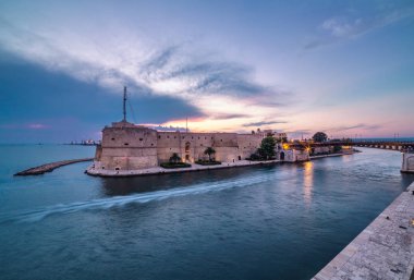 Taranto ancient fortress. Amazing sunset on city landscape. Italy panorama clipart