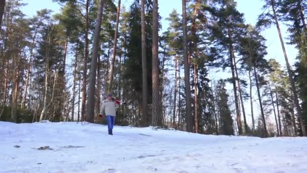 Человек с усами идет против красивого леса зимой — стоковое видео