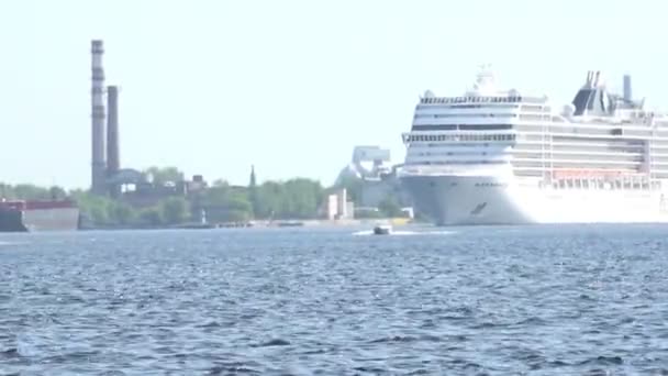 Large cruise ship sails on river blue water past green bank — Stock Video