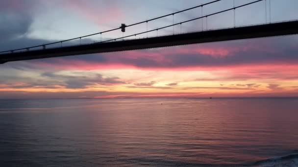 Bridge with long powerful ropes under cloudy sunset sky — Stock Video