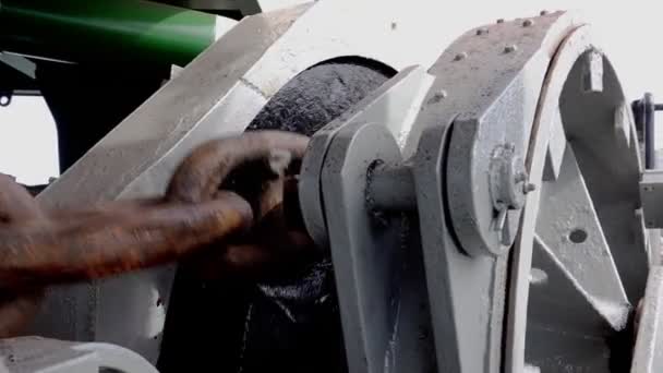 Спеціальне сіре металеве лебідкове колесо піднімає коричневий анкерний ланцюг — стокове відео