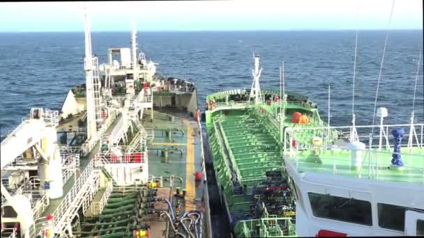 Modern oil tanker sails away from vessel with steel towers — Stock Video