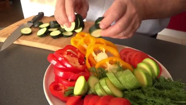Cozinheiro leva pedaços de berinjela e coloca no prato com legumes — Vídeo de Stock