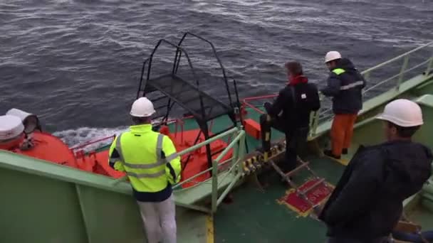 Лоцман меняет зеленый танкер оникс на маленькую лоцманскую моторную лодку — стоковое видео