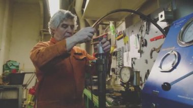 Gri saçlı adam önemli Natig Aliev tanker detaylarını onarıyor