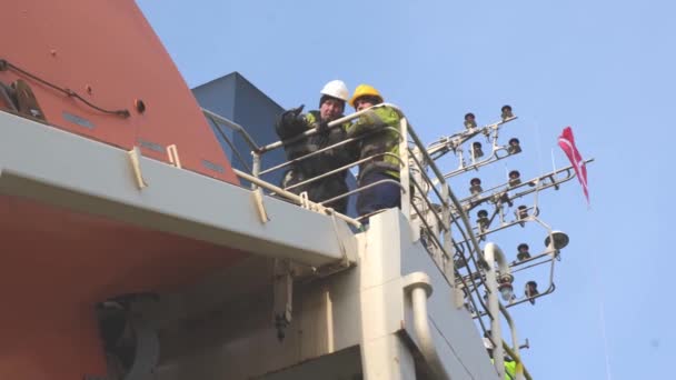 Tanker námořníci diskutovat o opravě záchranného člunu na horní palubě — Stock video