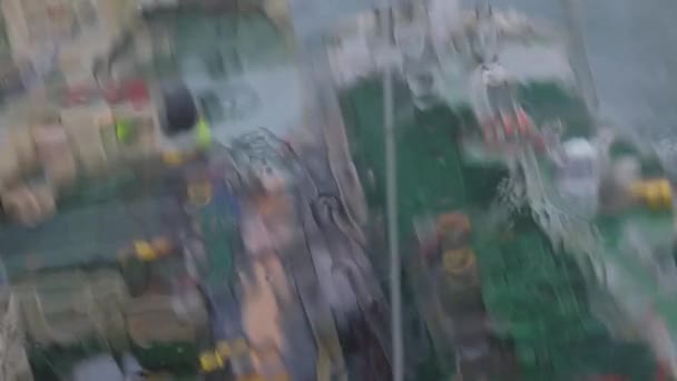 Heavy rain water falls down camera focusing on tankers — Stock Video