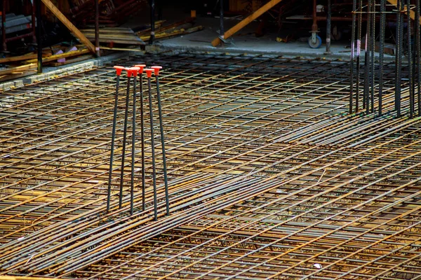 view of reinforcement of concrete with metal rods connected by wire. Preparation for pouring crutches preparing for building house
