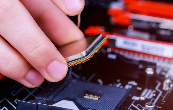 Computer technician installing CPU into motherboard. Close up. installed in PC motherboard.