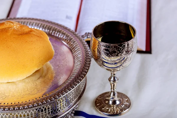 Close up of bread and a cup of red wine of thorn on wooden table for communion, Christian concept for reminder of Jesus