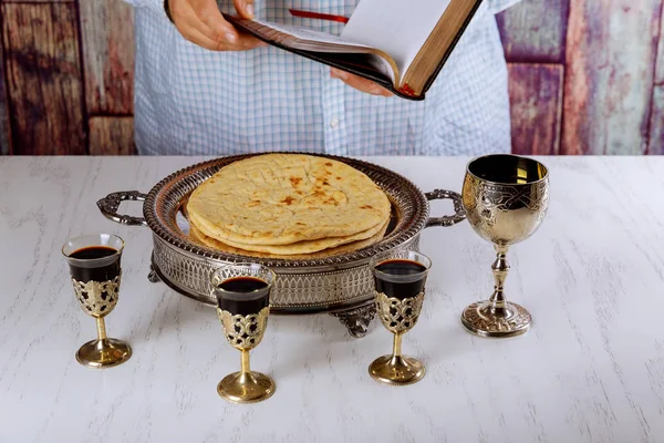 Holy communion in church still life red wine, bread and Bible. Reading the Bible at the beginning of communion