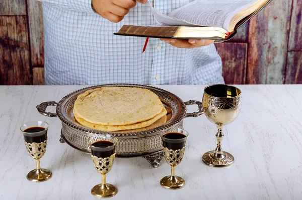 Holy communion on wooden table on church. Communion.Cup of glass with red wine, bread and Reading the Holy Bible