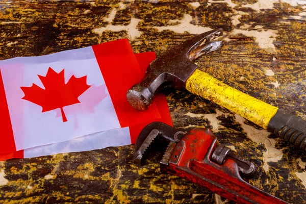 canada happy labor day hammer, wrench a wooden background. Labor day concept. canadian flag