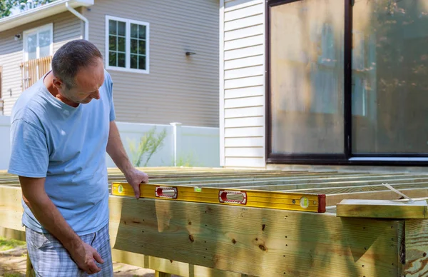 Close up of exterior timber decking building a backyard deck with composite deck boards
