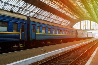Lviv Central Station trains stand at the station at sunrise time. clipart